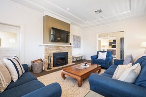 There's plenty of room for everyone in the sofas to watch a show in front of the fire.