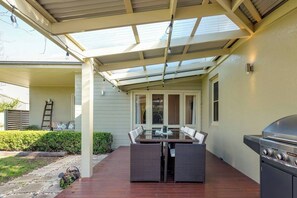 The undercover patio has a BBQ and alfresco dining by the beautiful garden.