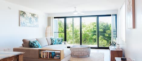 Open plan living looking out to the garden, river and ocean views