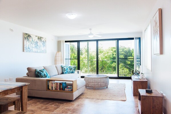 Open plan living looking out to the garden, river and ocean views