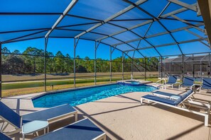 private SW facing pool with views of water and trees beyond.