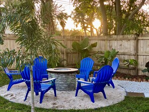 Gas fire pit in white sand to sink your toes into. 
