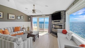 Wonderful living room with comfortable seating, slider to deck, TV and amazing views