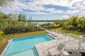 Outdoor entertainment area includes lounge chairs, propane grill, outdoor shower, and an outdoor dining table!
