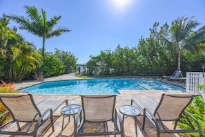 Outdoor entertainment area includes lounge chairs, propane grill, outdoor shower, and an outdoor dining table!