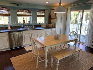 Kitchen opens onto spacious screened balcony.