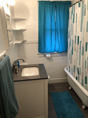 That’s a claw tub with a shower. Towels, wash rags, soap, and shampoo provided.