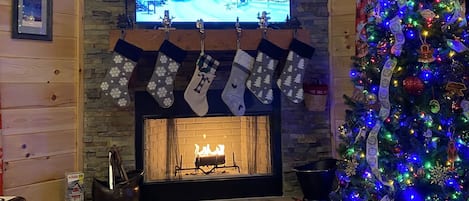 Living room with vaulted ceilings , mtn views & creek . Wood burning Fire Place