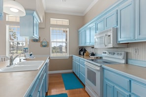 This beautiful blue kitchen comes fully equipped for your needs.