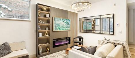 Living room featuring a Samsung frame smart TV & queen sleeper sofa