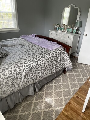 Bedroom 1 has one queen bed, 2 dressers, TV, and a vanity table