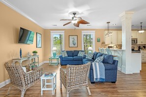Open living room area with windows overlooking the wetlands behind the home.