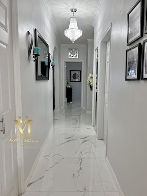 Entry way hallway with a beautiful chandelier