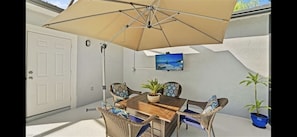 Poolside TV, fire table and dining area