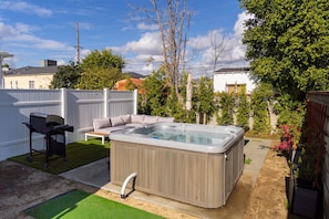 FENCED PATIO WITH HOT TUB, BBQ GRILL & OUTDOOR SEATING -- View 3D Virtual Tour of the Property Here: https://tinyurl.com/yzk7a7sx