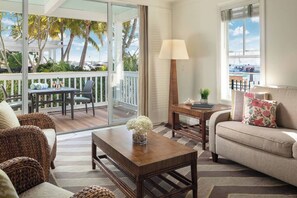 Spacious living room with furnished balcony.