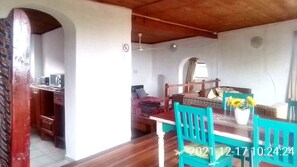 View of the dining table, Kitchen entrance and main bedroom 