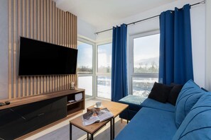 Living room with a comfortable sofa and TV. 
