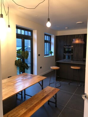 Spacious high spec kitchen with dining area opening onto garden courtyard