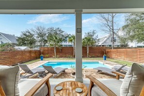 Covered patio overlooking pool deck