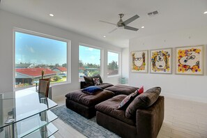 Living area - Picture windows illuminate this units unique art