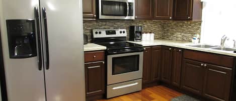 Complete kitchen with refrigerator, microwave, oven, and dishwasher