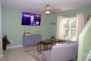 Downstairs' living room, equipped with two single size futon chairs