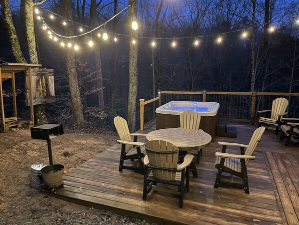 Unwind under the string lights with a soak in the hot tub and the sounds of nature all around.