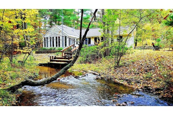 The Retreat Home is nestled on a  wooded setting along a babbling creek.