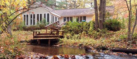 Retreat home nestled in the Manistee Forest along a babbling creek. 
