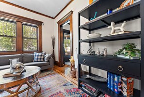 Living room shelves have a bunch of board games for guests to use.