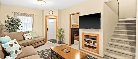 Living room with a 55” Flatscreen TV, Roku and DVD player