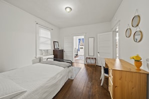 bedroom with full bed and work desk
