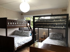 Bedroom two, upstairs. Tri bunk (double/single) and single bunks. Sleeps five.