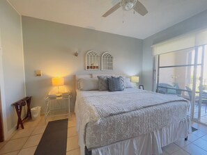 Serenity in the guest bedroom with a comfortable bed next to the glass door.