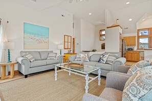 Seaside family room with cozy sofas and beachy charm!