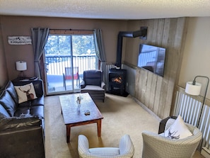 Side A: Living room with gas fireplace and view of the ski hill