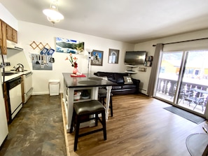 Full kitchen, Living room right next to the Fall River. Brand new wood floors!