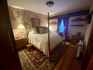 King bedroom with smart TV, 3 dressers, luggage rack + extra linens