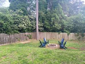 Come hang out in this large fenced in back yard with large fire pit and comfortable Adirondack chairs