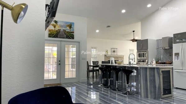 Porcelain floors with a Wine Cooler, Bar Stools Pop up wireless charger + more!