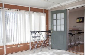 View from Florida room to the breakfast nook area inside the kitchen.