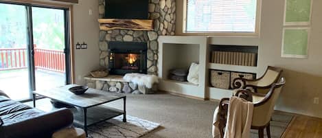 Cozy living room with gas fireplace and access to the large back deck