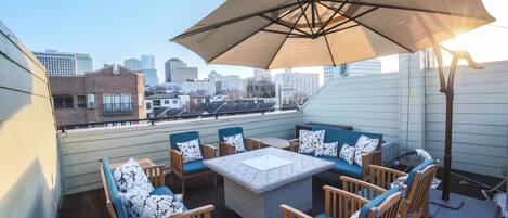 Large, private rooftop with comfortable seating and views of Downtown