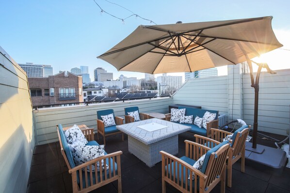 Large, private rooftop with comfortable seating and views of Downtown