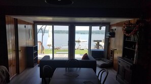 Looking out to deck & beach from dining area. Bedroom doors visible right & left