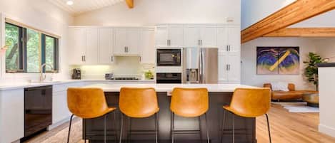 Updated, luxe kitchen with extra seating at the kitchen island