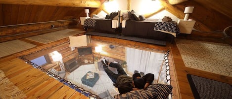 This loft features twin beds and a hammock netting area, perfect for lounging or sleeping.