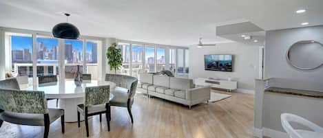 Dining area and living room, balcony access, views of Miami skyline