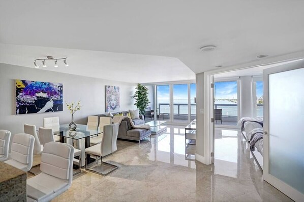 Dining area, living room, balcony access, view into 2nd bedroom